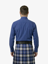 Man wearing a blue shirt and plaid kilt on a white background