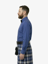 Man wearing a blue shirt and plaid kilt on a white background