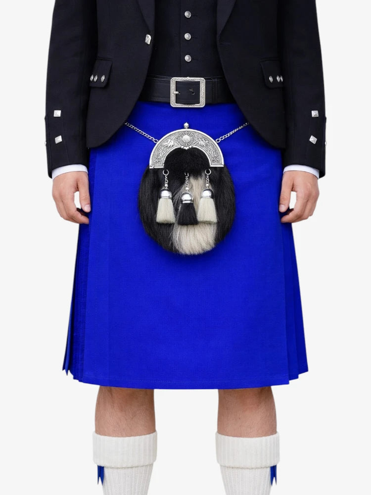 Person wearing a blue kilt with a sporran on a white background