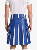 A person shown from the back wearing a bright blue pleated mini skirt with white side panels and white belt loops, paired with a white t-shirt against a light gray studio background.