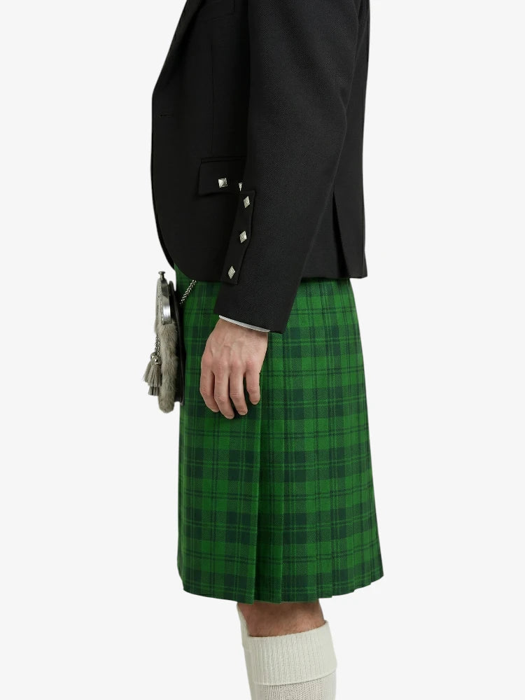 Person wearing a green plaid kilt with a black jacket on a white background