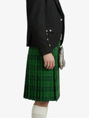 Person wearing a black blazer and green plaid kilt on a white background
