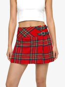 Red plaid skirt with black buckles worn by a person on a white background