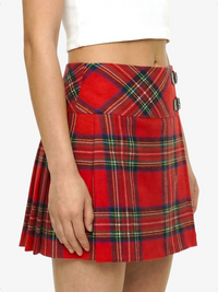 Red plaid skirt worn by a person on a white background