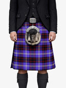 Person wearing a black suit with a blue plaid kilt on a white background