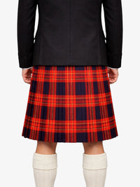 Person wearing a black jacket and red plaid kilt on a white background