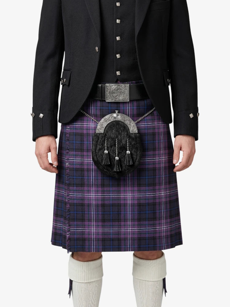 Person wearing a black jacket, purple plaid kilt, and white knee-high socks on a white background