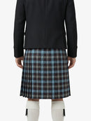 Person wearing a black jacket and plaid kilt on a white background