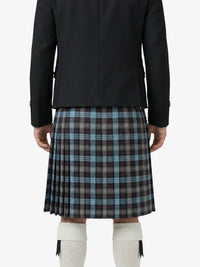 Person wearing a black jacket and plaid kilt on a white background