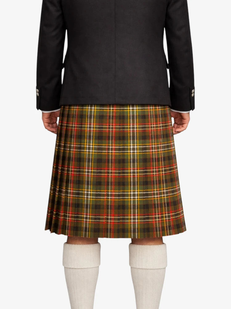 Person wearing a black jacket and plaid kilt on a white background