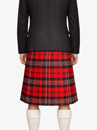 Person wearing a black jacket and red plaid kilt on a white background