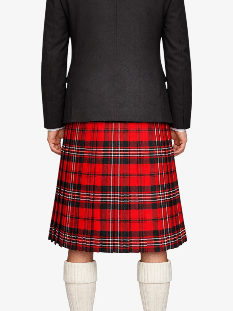 Person wearing a black jacket and red plaid kilt on a white background