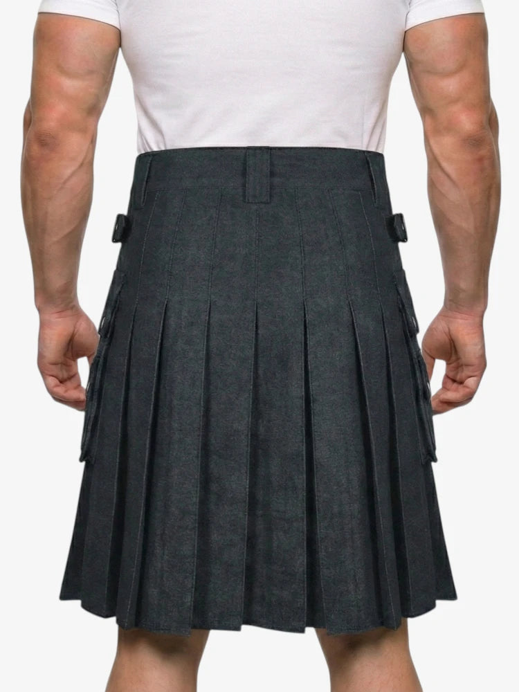 Person wearing a gray pleated kilt on a white background
