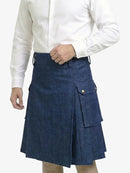Person wearing a blue denim kilt on a white background