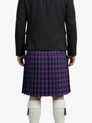 Person wearing a black jacket and a plaid kilt on a white background