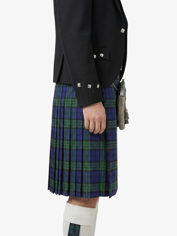Person wearing a black jacket and blue plaid kilt on a white background