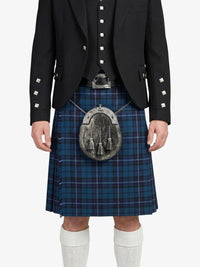Person wearing a traditional Scottish kilt with a jacket on a white background