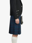 Person wearing a black jacket and blue plaid kilt on a white background