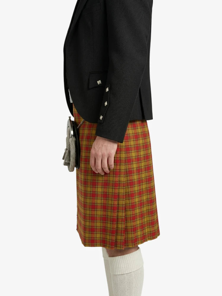 Person wearing a black jacket and red plaid kilt on a white background
