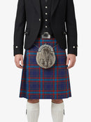 Person wearing a traditional Scottish kilt with a tartan pattern on a white background