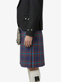 Person wearing a black blazer and blue plaid kilt on a white background