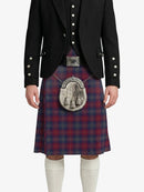 Person wearing a traditional Scottish kilt with a jacket on a white background