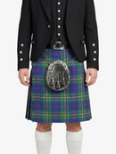 Person wearing a black jacket and a colorful plaid kilt on a white background