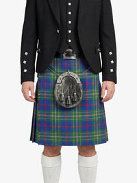 Person wearing a black jacket and a colorful plaid kilt on a white background