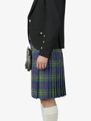 Person wearing a black blazer and a plaid kilt on a white background