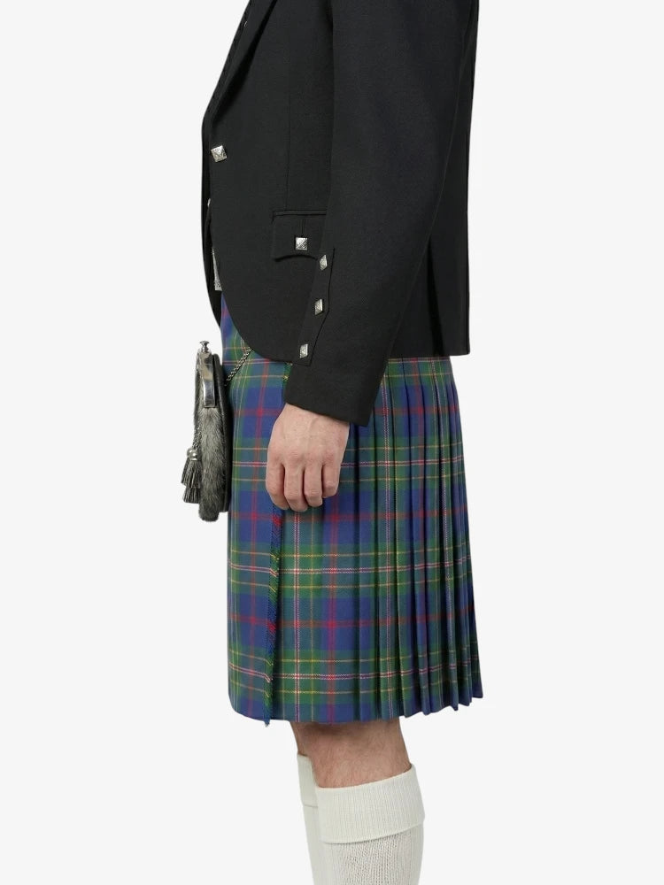 Person wearing a black blazer and a plaid kilt on a white background