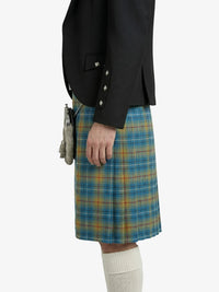 Person wearing a black jacket and plaid kilt on a white background