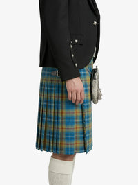 Person wearing a black jacket and blue plaid kilt on a white background