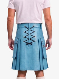 A person shown from the back wearing a light blue pleated kilt with black lace-up detailing down the center and side flap pockets, paired with a pale pink T-shirt and light socks against a plain light background.