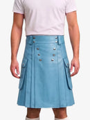 A person wearing a light blue faux-leather kilt with silver-tone double-breasted buttons and side flap pockets, paired with a pale pink t-shirt against a light gray background.