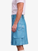 A person wearing a light blue pleated kilt-style skirt with flap pockets and silver-tone hardware, shown from the side against a plain light background.