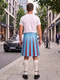 A man standing on a city sidewalk, viewed from behind, wearing a white t-shirt, a light blue pleated kilt with red vertical stripes, white knee-high socks, and black shoes. Buildings, trees, a black Mercedes car, and a bicycle are visible in the background.