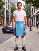 A man stands on a city sidewalk wearing a bright blue leather kilt with red side panels, a white t-shirt, white knee-high socks, and black leather shoes. Buildings, trees, a black Mercedes, and a bicycle are visible in the background.