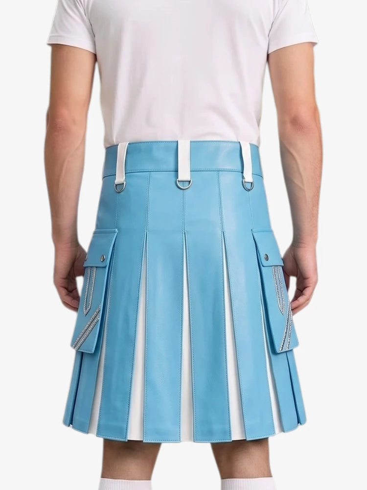 A model shown from the back wearing a light blue pleated faux-leather kilt with white accents, including belt loops, side zipper details, and vertical pleats, paired with a white t-shirt.