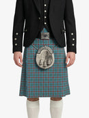 Person wearing a traditional Scottish kilt with a jacket on a white background