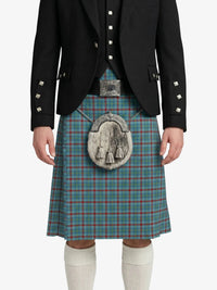 Person wearing a traditional Scottish kilt with a jacket on a white background