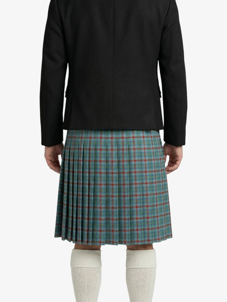 Person wearing a black jacket and plaid kilt on a white background