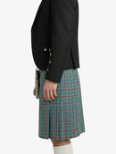 Person wearing a black blazer and plaid Kilt on a white background