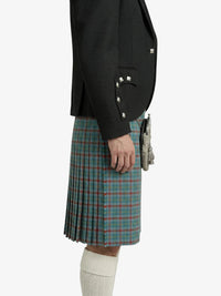 Person wearing a black jacket and green plaid kilt on a white background