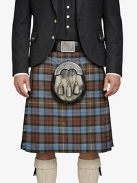 Person wearing a traditional Scottish kilt with a tartan pattern on a white background