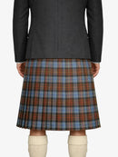 Person wearing a dark gray coat and plaid kilt on a white background