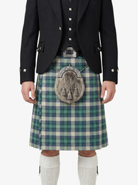 Person wearing a traditional Scottish kilt with a tartan pattern on a white background