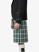 Person wearing a black jacket and plaid kilt on a white background