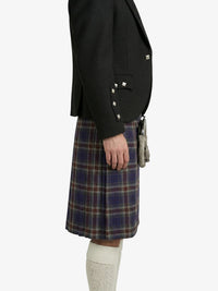 Person wearing a black blazer and plaid kilt on a white background