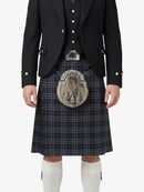 Person wearing a traditional Scottish kilt with a sporran on a white background