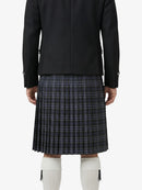 Person wearing a black jacket and plaid kilt on a white background